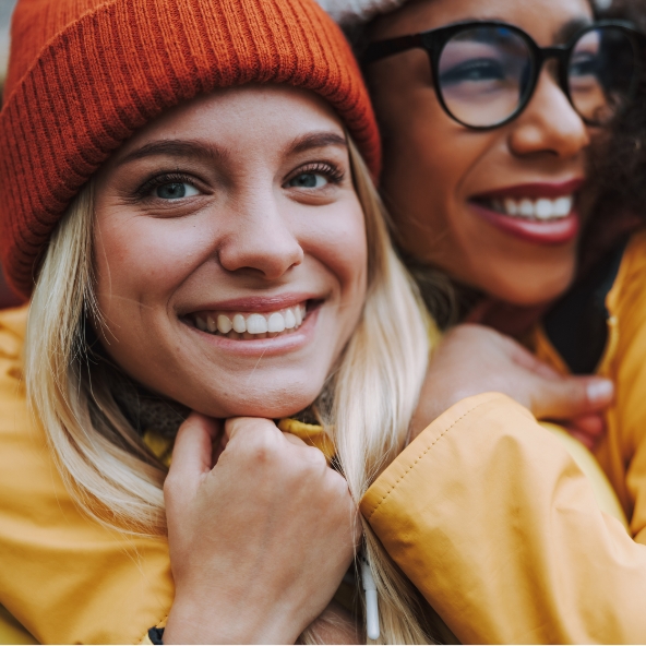 Two culturally diverse women smiling